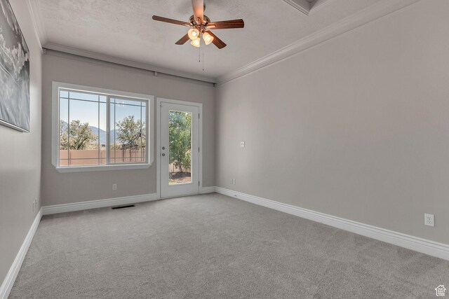 6861 S Triumph Ln, West Jordan, UT 84084 - spare room featuring carpet flooring, a ceiling fan, baseboards, ornamental molding, and a textured ceiling
