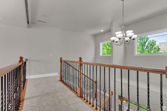 6861 S Triumph Ln, West Jordan, UT 84084 - hall with a chandelier, an upstairs landing, recessed lighting, baseboards, and carpet floors