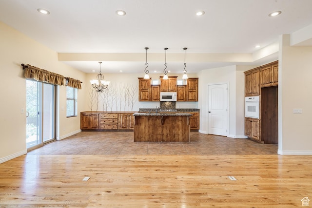 1059 S Ridge Rd, Cedar City, UT 84720 - kitchen featuring white appliances, light wood-style flooring, and brown cabinets