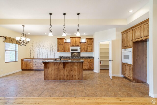 1059 S Ridge Rd, Cedar City, UT 84720 - kitchen with baseboards, brown cabinetry, white appliances, and recessed lighting
