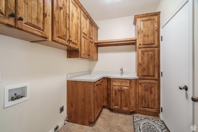 1059 S Ridge Rd, Cedar City, UT 84720 - washroom featuring hookup for an electric dryer, a sink, cabinet space, light tile patterned floors, and hookup for a washing machine