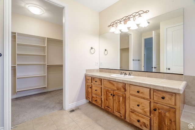 1059 S Ridge Rd, Cedar City, UT 84720 - full bathroom featuring vanity, visible vents, tile patterned floors, and a spacious closet
