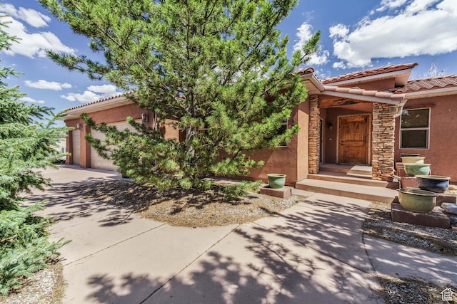 1059 S Ridge Rd, Cedar City, UT 84720 - view of front of property featuring a tile roof, stucco siding, and an attached garage