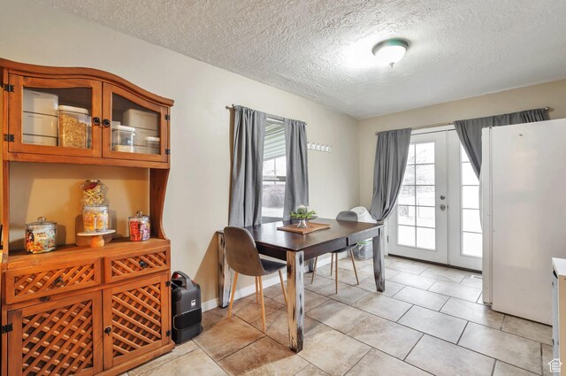 748 Maple St, Ogden, UT 84403 - dining area featuring a textured ceiling and light tile patterned flooring