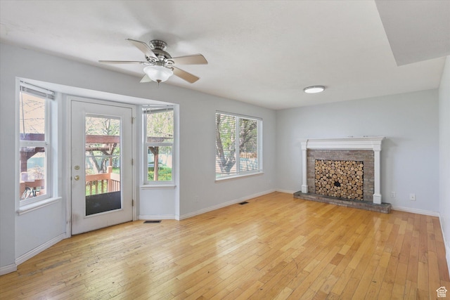799 Country Club Dr, Stansbury Park, UT 84074 - unfurnished living room featuring light wood-style floors, ceiling fan, a fireplace, baseboards, and visible vents