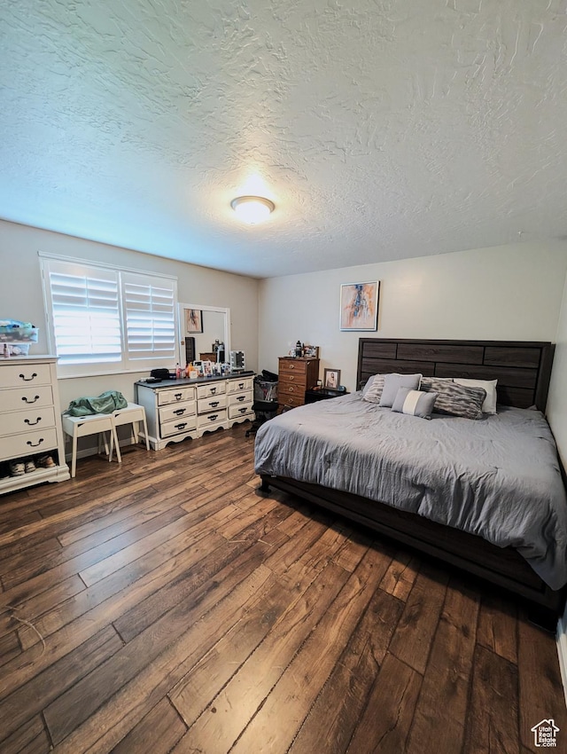 4635 W Eskesen Dr S, West Valley City, UT 84120 - bedroom featuring dark wood-style floors and a textured ceiling