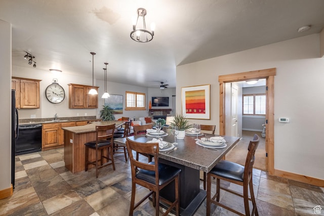 5519 N Lillehammer Ln Unit 1201, Park City, UT 84098 - dining space featuring ceiling fan, stone finish floor, a wealth of natural light, and baseboards