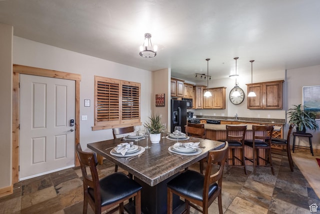 5519 N Lillehammer Ln Unit 1201, Park City, UT 84098 - dining room featuring baseboards, a notable chandelier, and stone finish floor