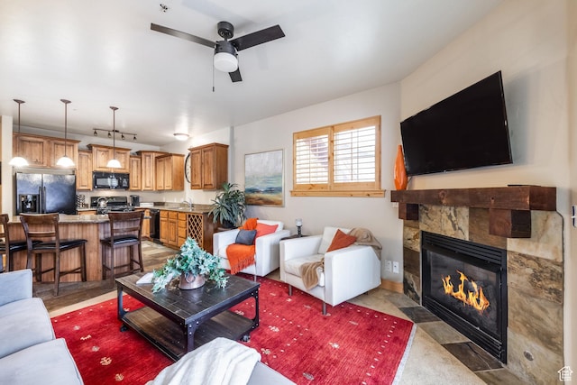 5519 N Lillehammer Ln Unit 1201, Park City, UT 84098 - living room featuring a ceiling fan and a stone fireplace
