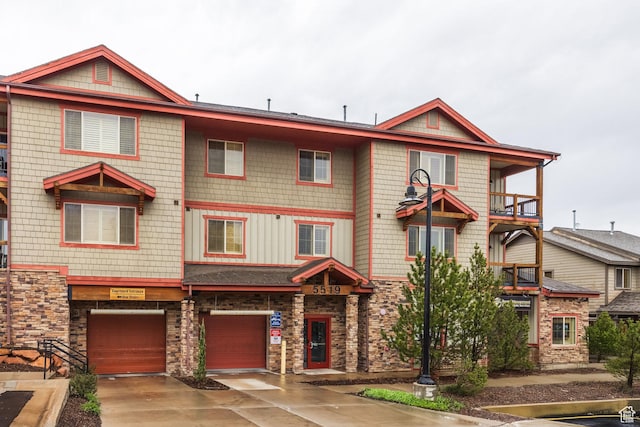 5519 N Lillehammer Ln Unit 1201, Park City, UT 84098 - view of front of property featuring driveway, stone siding, and a garage