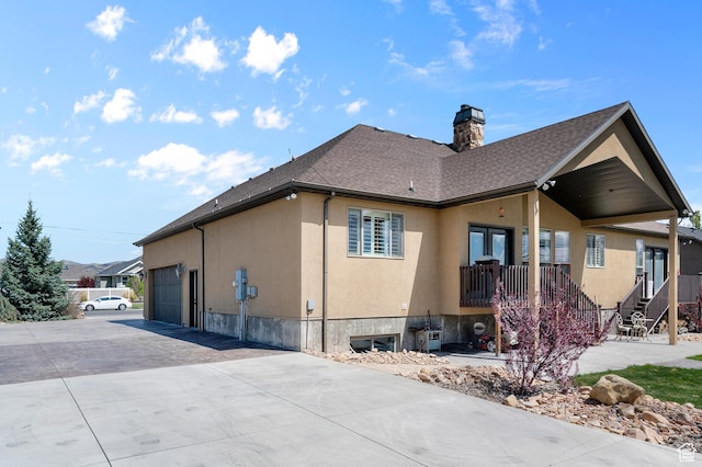 2277 W 900 N, Lehi, UT 84043 - view of side of home with stucco siding, a chimney, a shingled roof, and a garage
