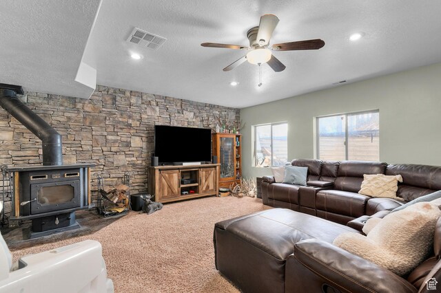 2277 W 900 N, Lehi, UT 84043 - living room featuring carpet, visible vents, a ceiling fan, a textured ceiling, and a wood stove