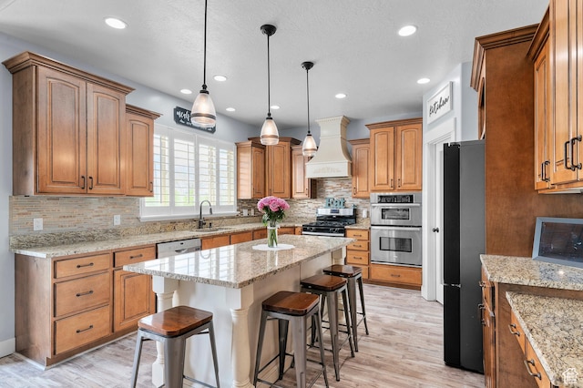 2277 W 900 N, Lehi, UT 84043 - kitchen with custom range hood, a sink, appliances with stainless steel finishes, a kitchen bar, and light wood-type flooring