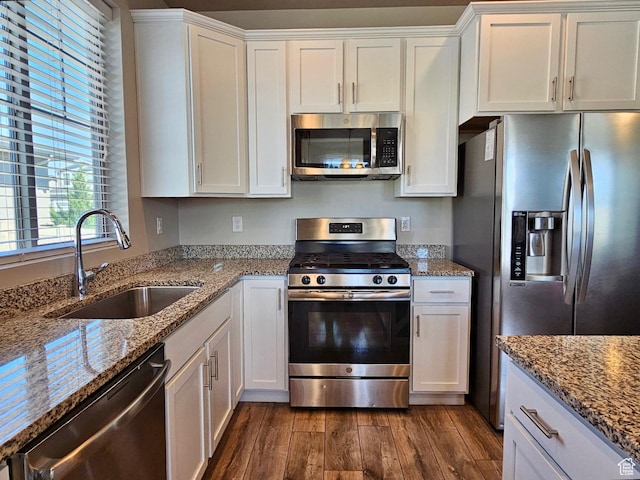 1013 W 90 S, Spanish Fork, UT 84660 - kitchen featuring appliances with stainless steel finishes, a sink, dark wood-style flooring, white cabinets, and light stone countertops