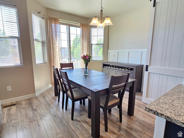1013 W 90 S, Spanish Fork, UT 84660 - dining space with light wood-type flooring, healthy amount of natural light, a chandelier, and baseboards