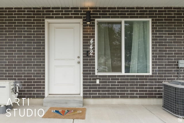 442 E Depot St Unit 107, Clearfield, UT 84015 - view of exterior entry featuring central AC and brick siding