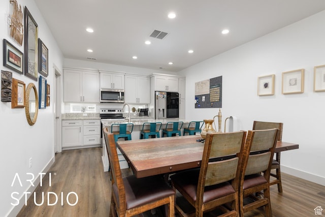 442 E Depot St Unit 107, Clearfield, UT 84015 - dining space with wood finished floors, recessed lighting, visible vents, and baseboards