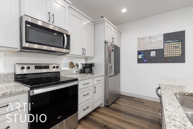 442 E Depot St Unit 107, Clearfield, UT 84015 - kitchen with white cabinets, stainless steel appliances, light stone countertops, recessed lighting, and dark wood-type flooring