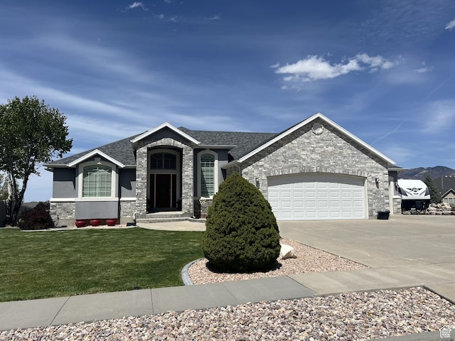 1307 E Brandy Ln S, Tooele, UT 84074 - view of front of home with concrete driveway, stone siding, a front yard, and an attached garage