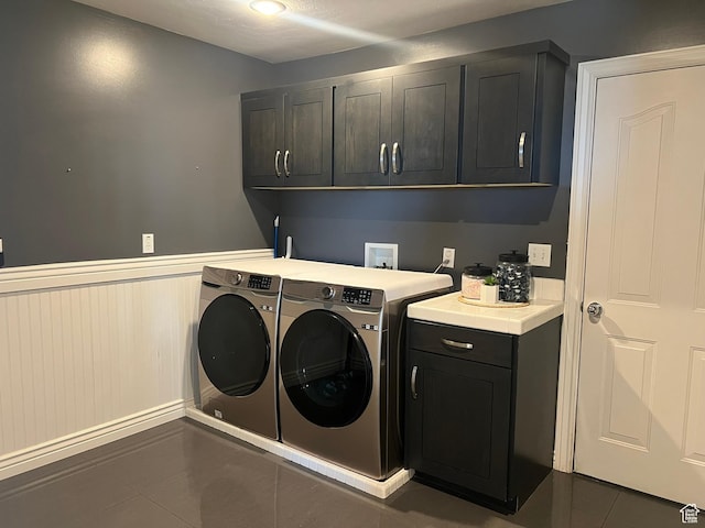 1307 E Brandy Ln S, Tooele, UT 84074 - laundry room featuring tile patterned flooring, a wainscoted wall, washer and dryer, and cabinet space