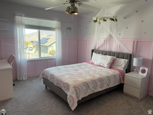 1307 E Brandy Ln S, Tooele, UT 84074 - carpeted bedroom featuring a decorative wall, a wainscoted wall, and a ceiling fan