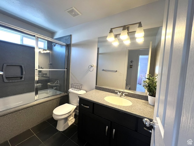 1307 E Brandy Ln S, Tooele, UT 84074 - full bath with vanity, bath / shower combo with glass door, toilet, visible vents, and tile patterned flooring