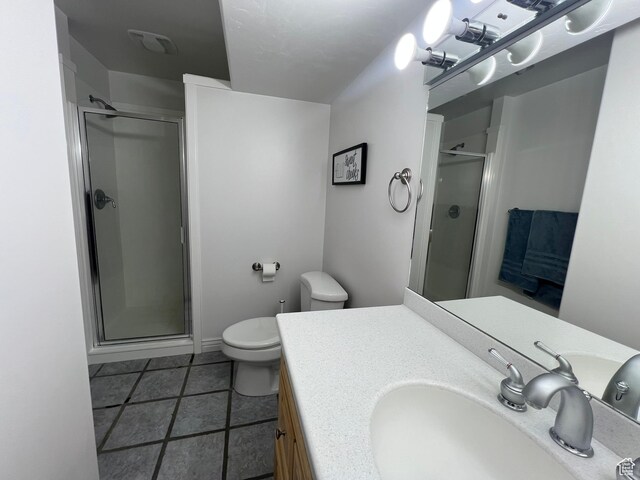 1307 E Brandy Ln S, Tooele, UT 84074 - bathroom featuring a stall shower, toilet, tile patterned flooring, and vanity