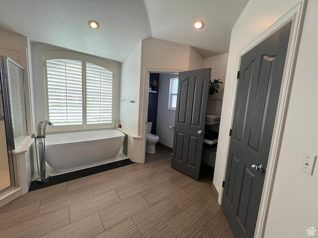 1307 E Brandy Ln S, Tooele, UT 84074 - bathroom with recessed lighting, a shower stall, toilet, a freestanding bath, and lofted ceiling