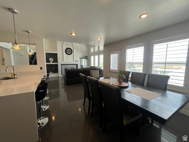1307 E Brandy Ln S, Tooele, UT 84074 - dining room with recessed lighting, a tile fireplace, dark tile patterned floors, and built in features