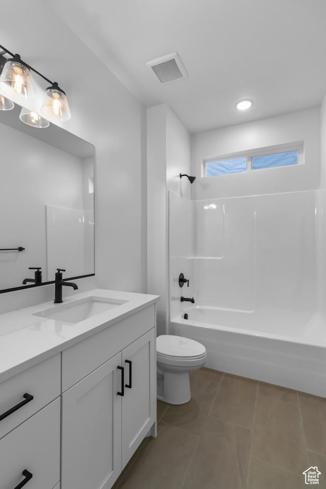 full bath with visible vents, toilet, vanity,  shower combination, and tile patterned flooring