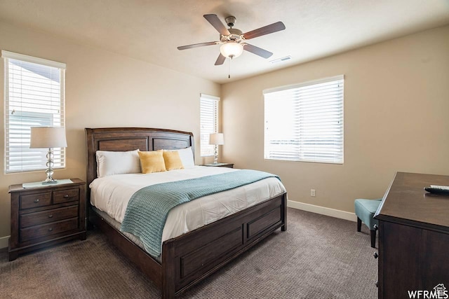 3800 N Paradise Village Dr Unit 1, Santa Clara, UT 84765 - bedroom with visible vents, multiple windows, dark colored carpet, and baseboards