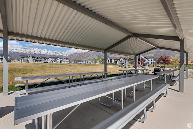view of property's community featuring a residential view, a mountain view, and a lawn