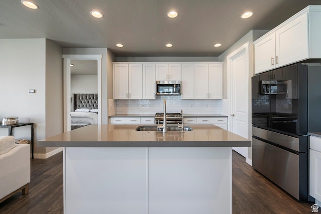 kitchen with recessed lighting, a sink, white cabinetry, and stainless steel appliances