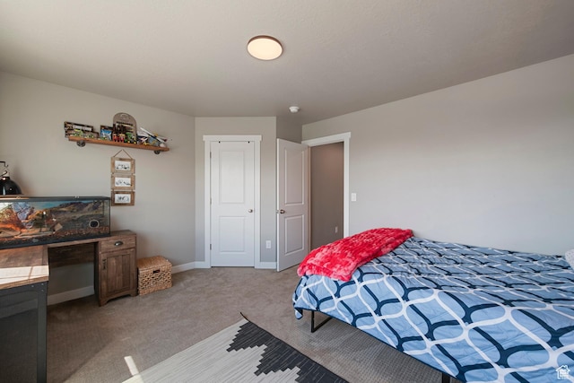 bedroom with light colored carpet and baseboards