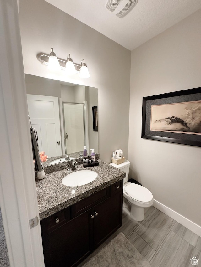 2743 W Lacewood Dr S, Taylorsville, UT 84129 - full bathroom with vanity, toilet, a stall shower, visible vents, and baseboards
