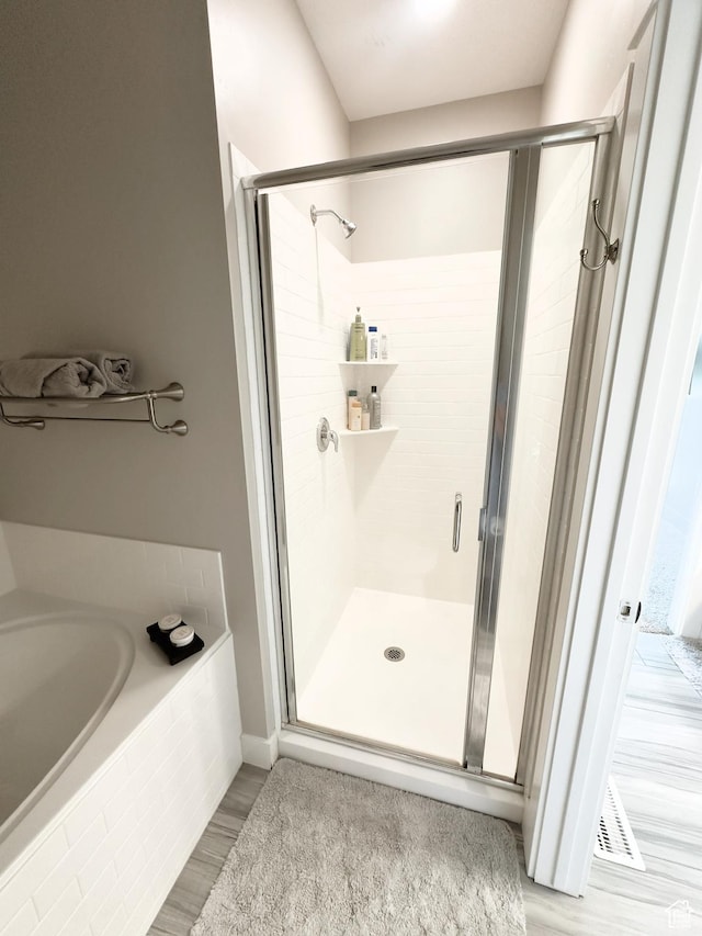 2743 W Lacewood Dr S, Taylorsville, UT 84129 - full bathroom featuring a stall shower, a bath, wood finished floors, and baseboards