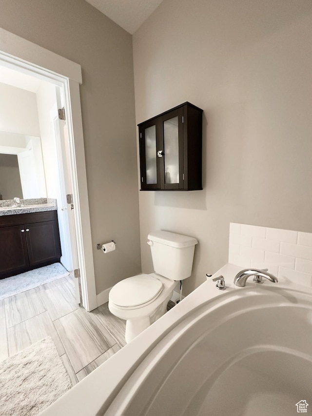 2743 W Lacewood Dr S, Taylorsville, UT 84129 - bathroom with vanity, toilet, a bath, and baseboards