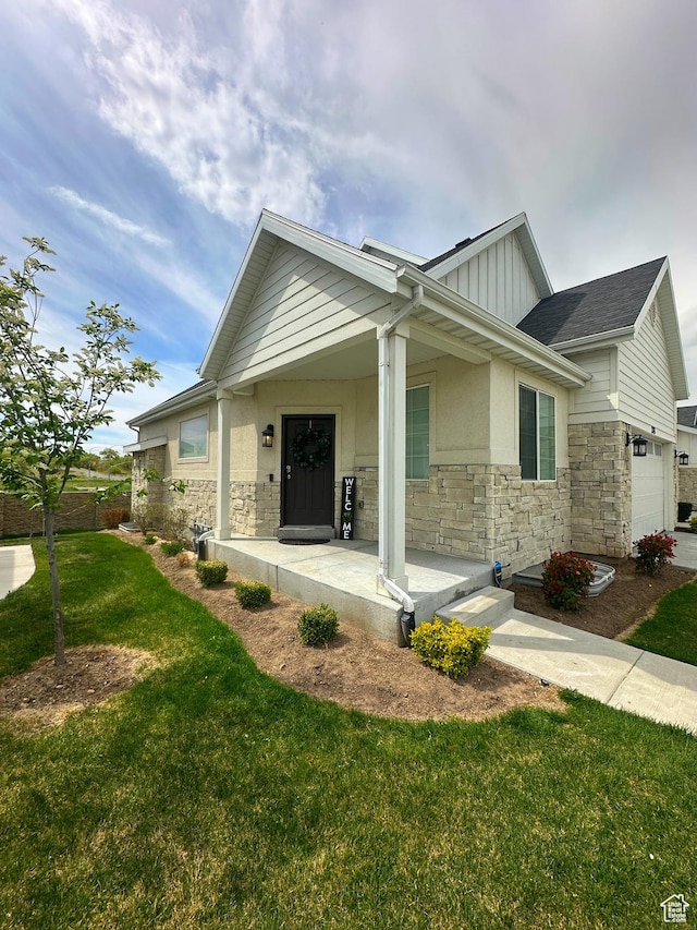 2743 W Lacewood Dr S, Taylorsville, UT 84129 - exterior space featuring a porch, board and batten siding, a front yard, and stone siding