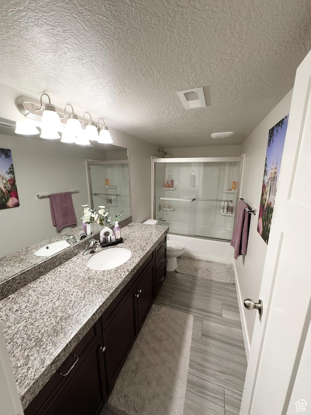 2743 W Lacewood Dr S, Taylorsville, UT 84129 - bathroom with enclosed tub / shower combo, toilet, a textured ceiling, and vanity