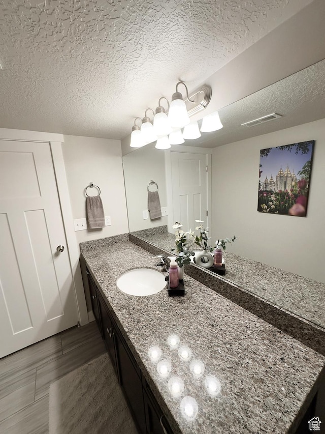 2743 W Lacewood Dr S, Taylorsville, UT 84129 - bathroom with a textured ceiling, visible vents, and vanity