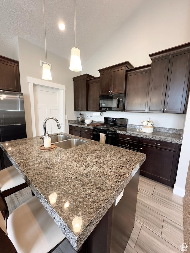 2743 W Lacewood Dr S, Taylorsville, UT 84129 - kitchen featuring lofted ceiling, a sink, dark brown cabinets, black appliances, and a kitchen bar