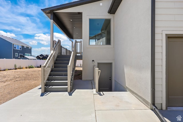 1107 S 4475 W, West Point, UT 84015 - view of exterior entry featuring stucco siding and a patio
