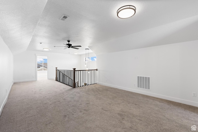 1107 S 4475 W, West Point, UT 84015 - additional living space with vaulted ceiling, carpet floors, a textured ceiling, ceiling fan, and plenty of natural light