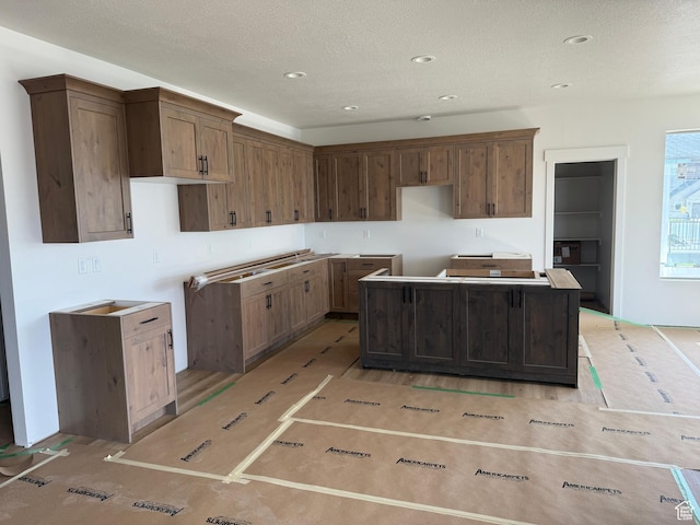 1107 S 4475 W, West Point, UT 84015 - kitchen featuring a kitchen island, a textured ceiling, and recessed lighting