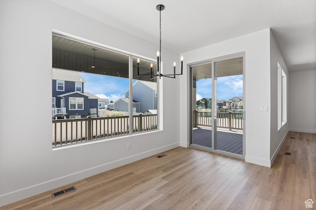 1107 S 4475 W, West Point, UT 84015 - unfurnished dining area featuring wood finished floors, a chandelier, a water view, and a residential view