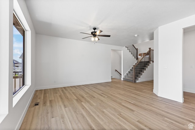 1107 S 4475 W, West Point, UT 84015 - unfurnished living room featuring light wood-style floors, a ceiling fan, and stairs