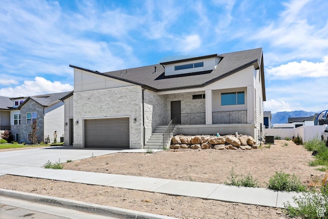 1107 S 4475 W, West Point, UT 84015 - view of front of property featuring concrete driveway, a porch, stone siding, a garage, and a shingled roof