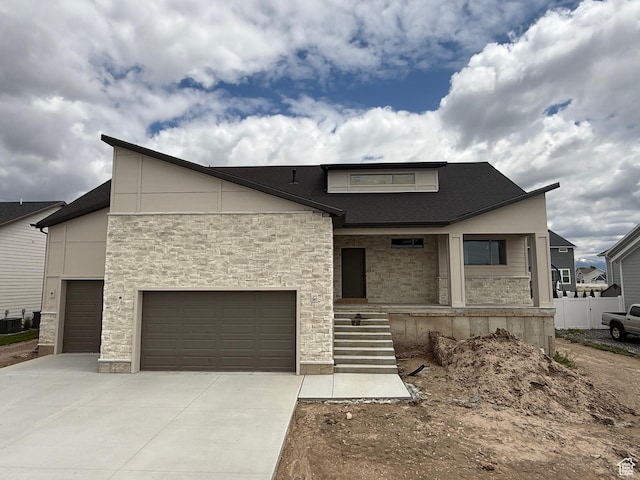 1107 S 4475 W, West Point, UT 84015 - modern home featuring stone siding, driveway, a garage, and covered porch