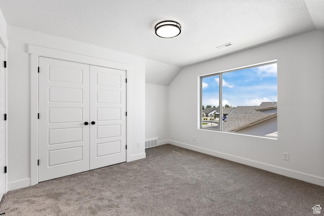1107 S 4475 W, West Point, UT 84015 - unfurnished bedroom featuring lofted ceiling, carpet, a closet, and a textured ceiling