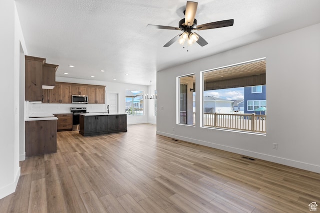 1107 S 4475 W, West Point, UT 84015 - unfurnished living room with light wood-type flooring, ceiling fan, and recessed lighting